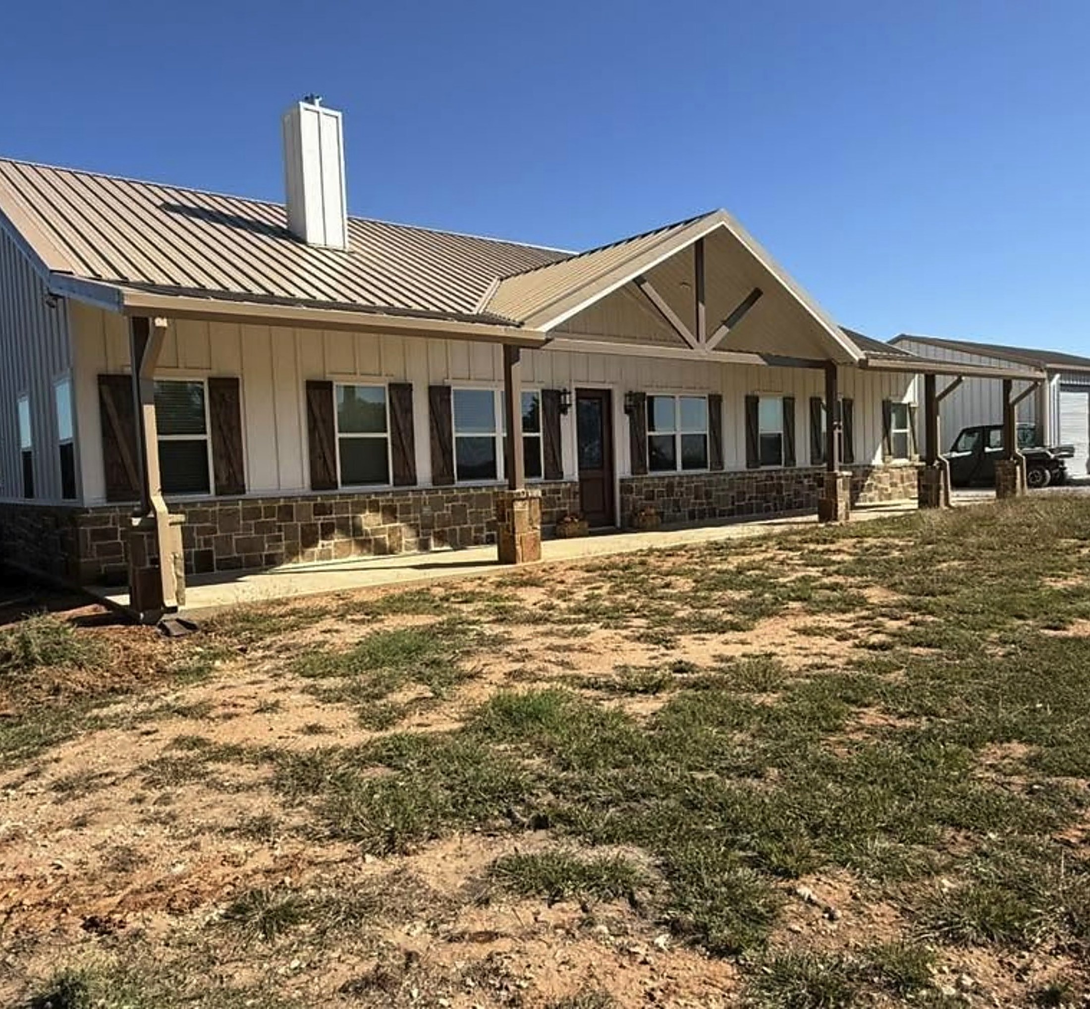 Ranch style home with standing seam metal roof