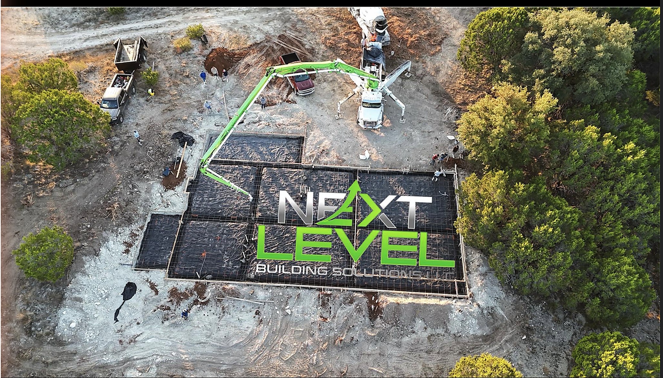 Aerial view of a Next Level slab pour with pump truck and crew