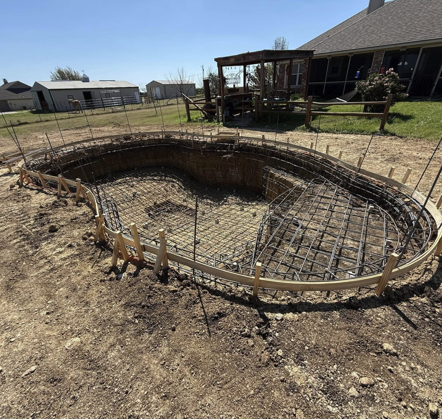 Rebar cage tied for a pool shell on a rural lot