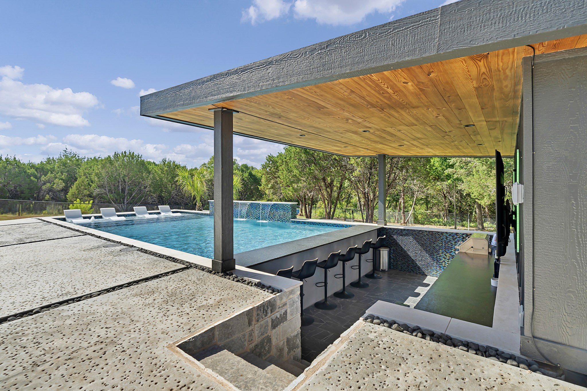 Swim up bar under a modern pavilion beside the pool
